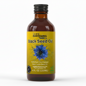 Bottle of black seed oil with a blue flower graphic on a white background